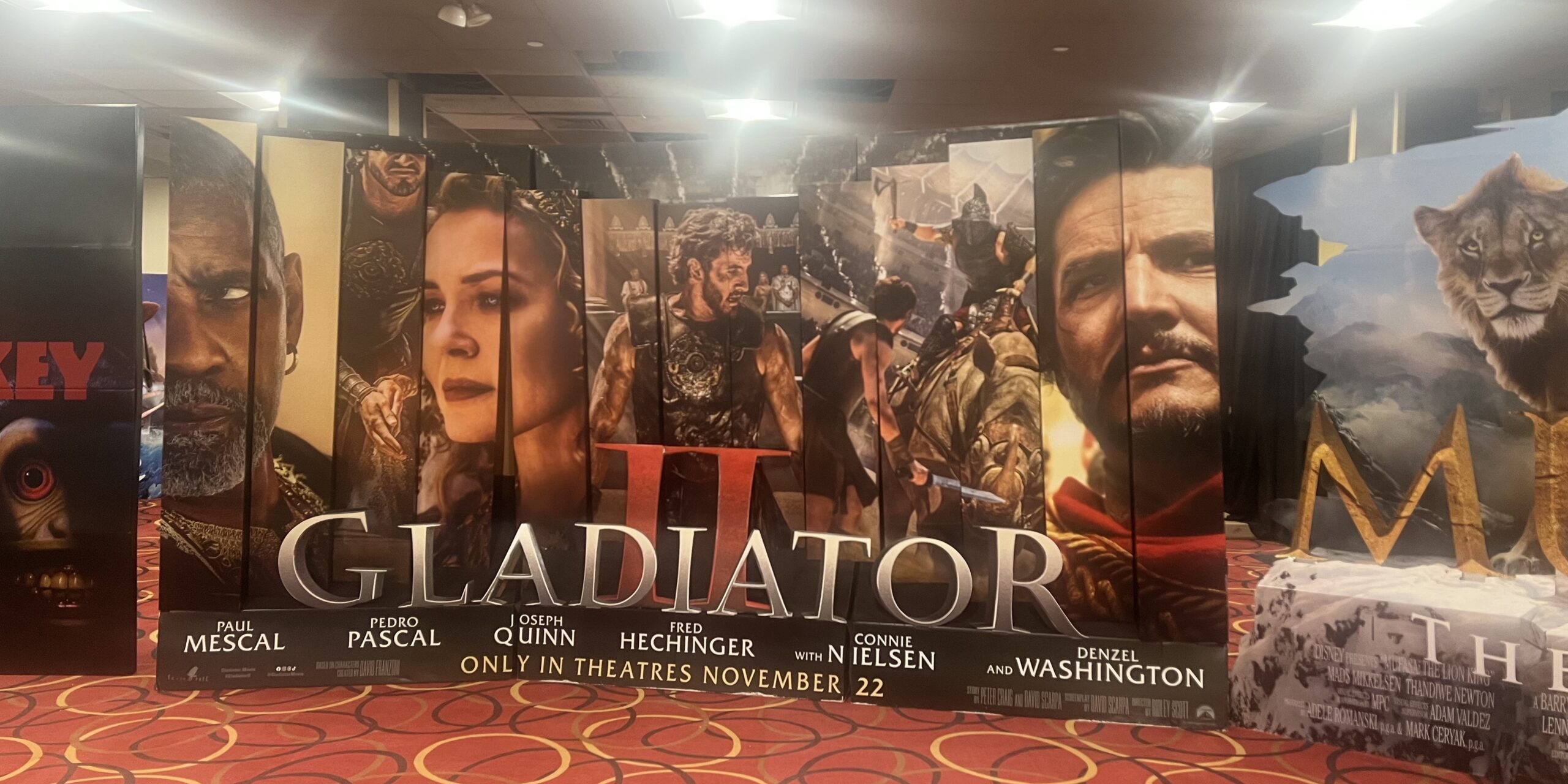 ID: Photo of the Gladiator II film promotional lobby stand