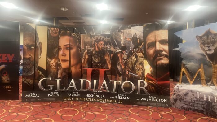 ID: Photo of the Gladiator II film promotional lobby stand