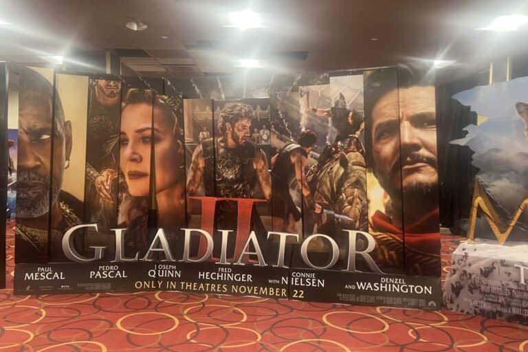 ID: Photo of the Gladiator II film promotional lobby stand