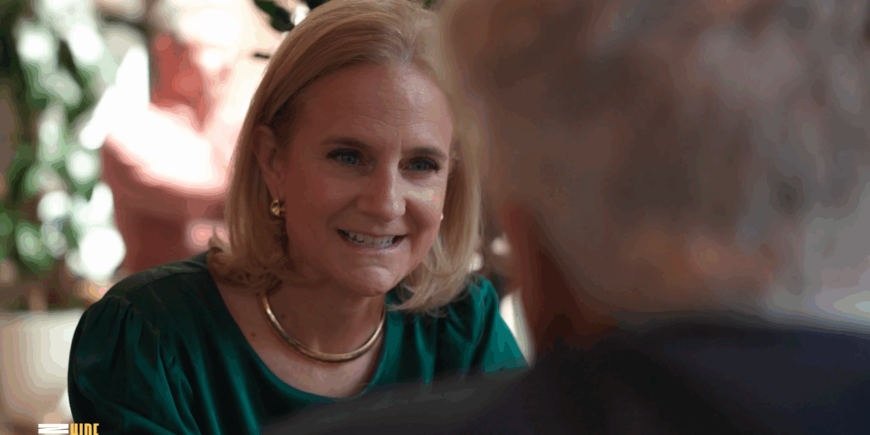 Me (in green top with gold necklace/earrings) listening during a conversation.