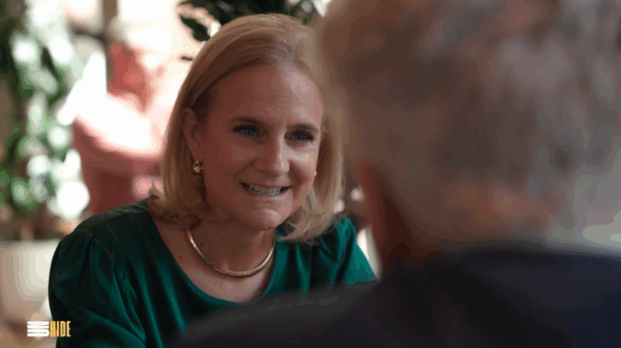 Me (in green top with gold necklace/earrings) listening during a conversation.