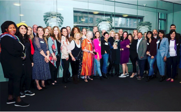 Group photo of people standing together at an NSA-NYC event, smiling toward the camera. Photo credit: John DeMato