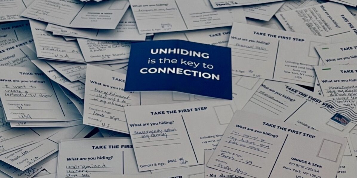 Pile of handwritten postcards answering the question “What are you hiding?” with a blue card in the center reading “Unhiding is the key to Connection."