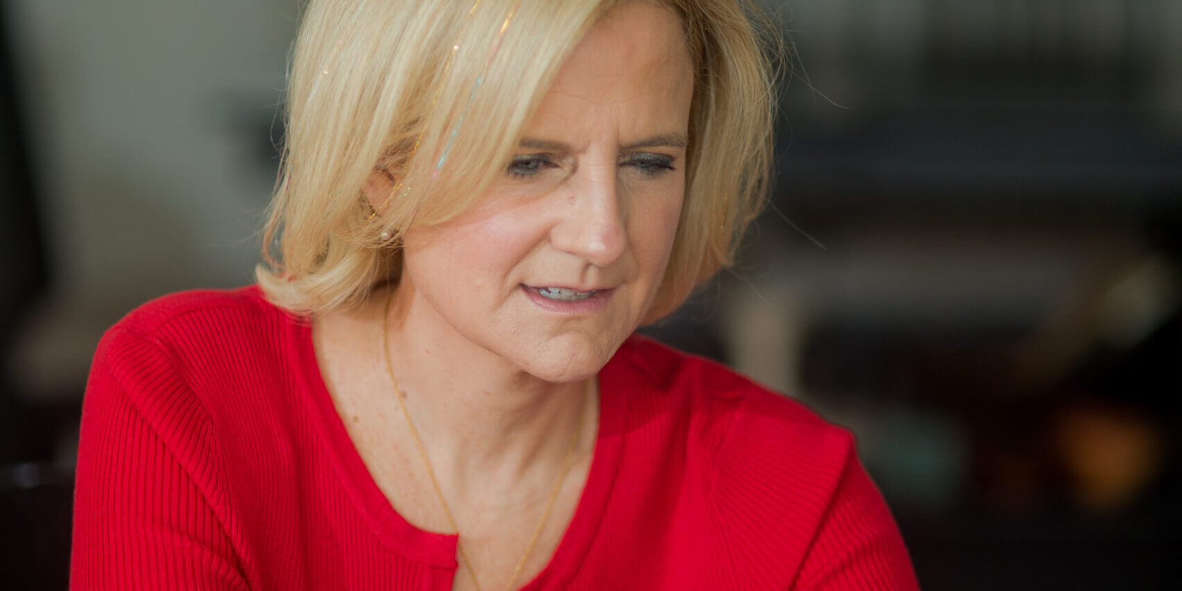 Ruth Rathblott sitting at a laptop. Photo: Maggie Marguerite Studio.
