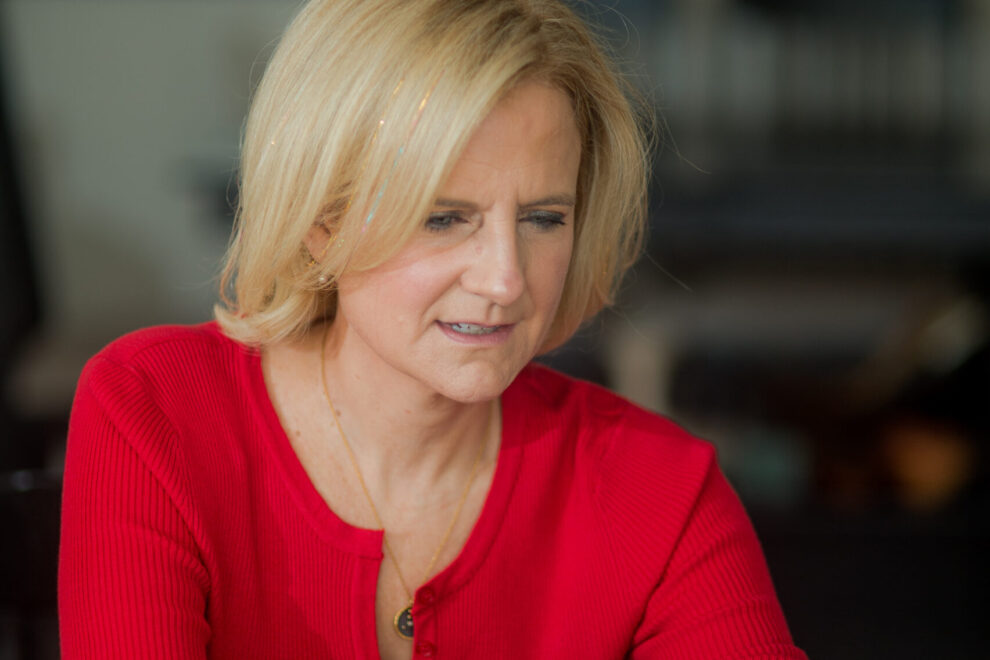Ruth Rathblott sitting at a laptop. Photo: Maggie Marguerite Studio.