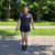 Me jumping rope outdoors using an EazyHold wristband, with both feet off the ground.